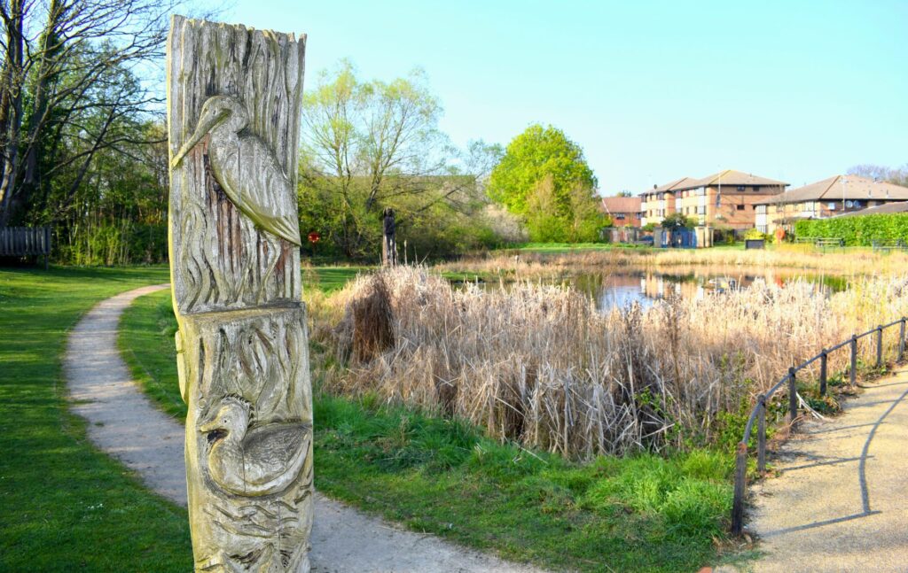 Animal themed wood carving totem pole in park in Forest Gate